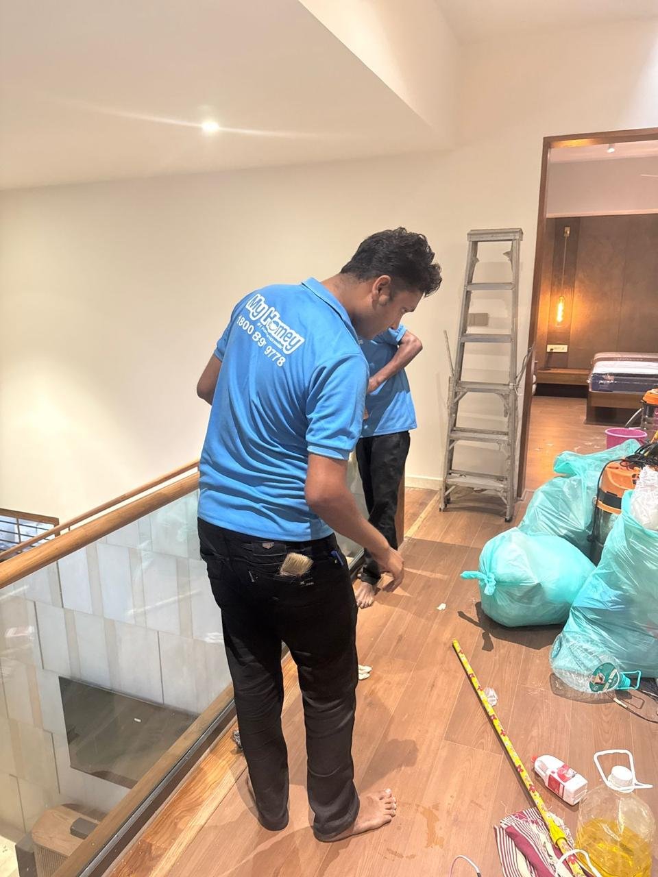 A cleaning team member during a post-renovation cleanup in a Kochi home